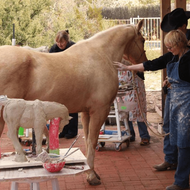 student working on a horse scultputre